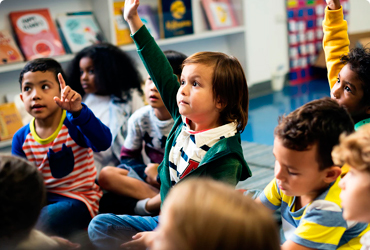 Elementary School Students In The Research Triangle Raise Hands In Class
