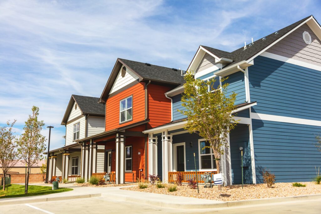 Housing development showing three houses in a row on a sunny day